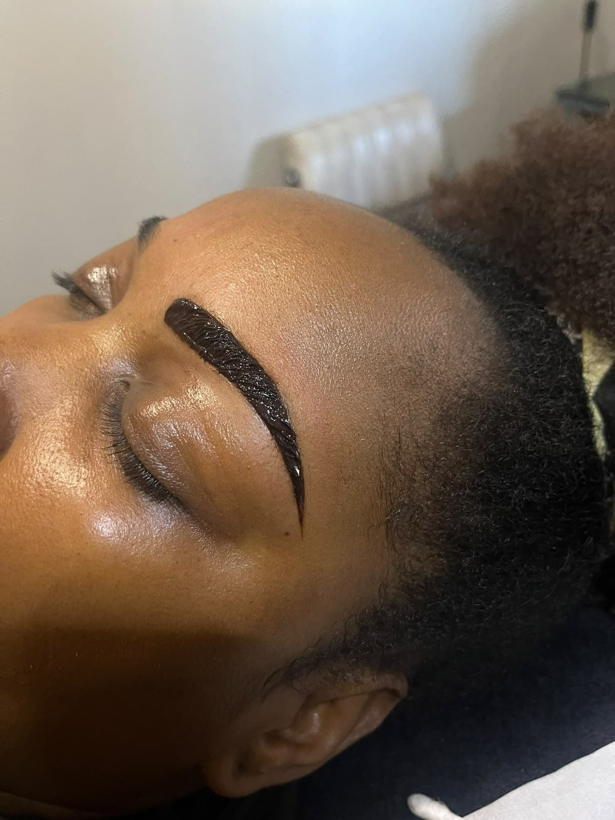 Henna brow tint being applied for a defined eyebrow shape