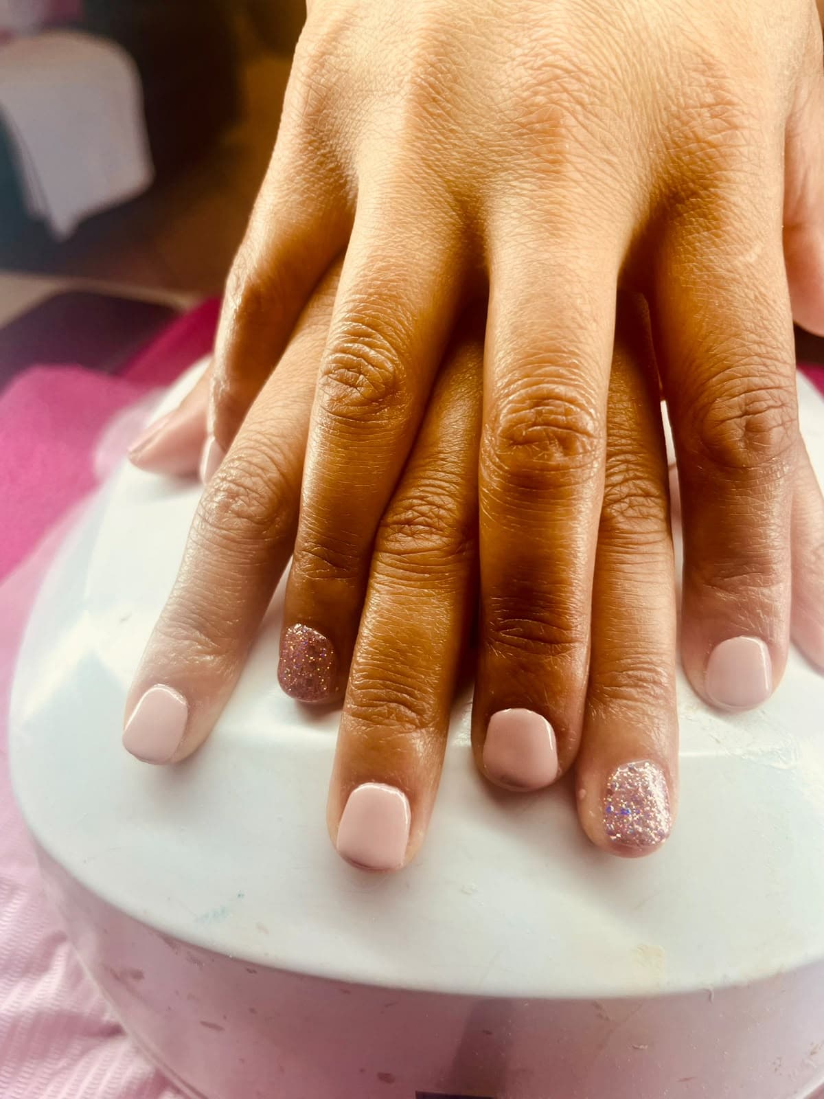 Baby pink gel manicure with rose-gold glitter accent nails
