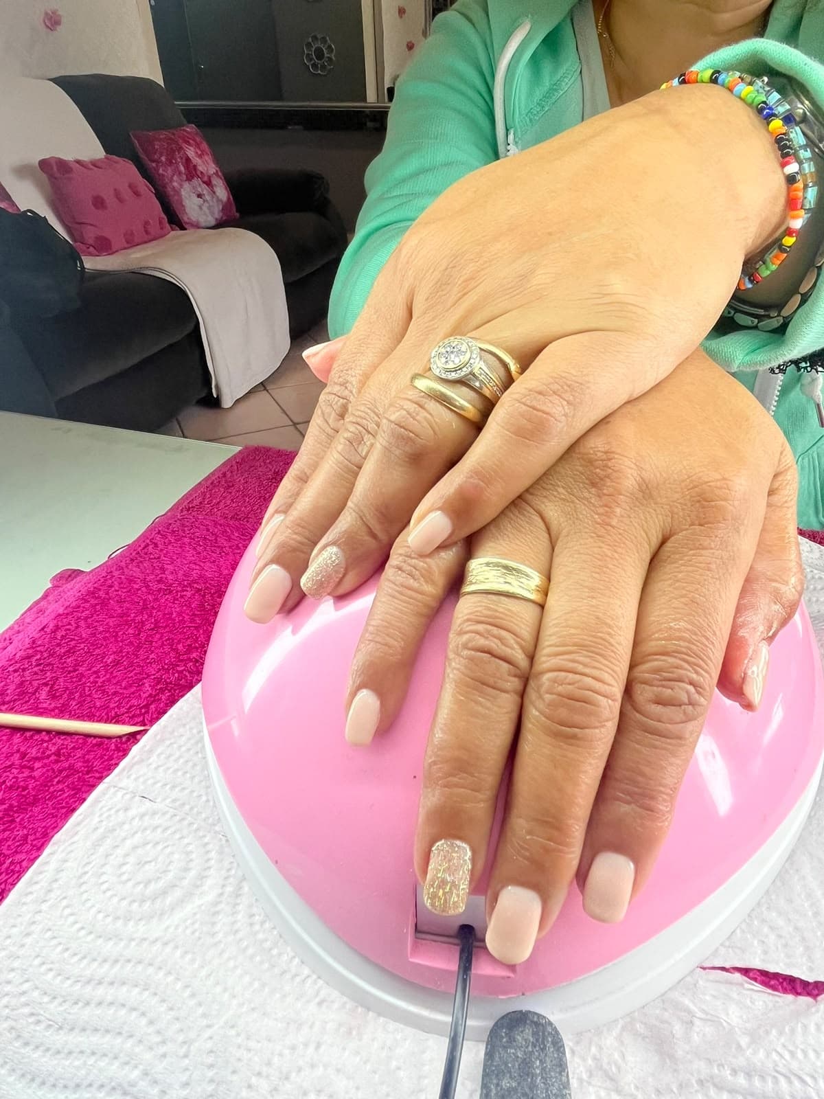 Nude pink gel manicure with sparkling glitter accent nails