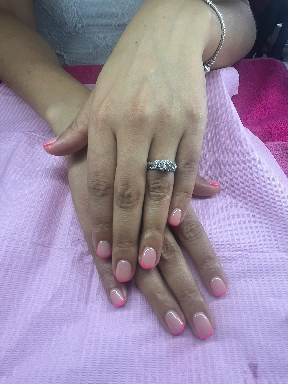 Short nude gel nails with bright pink French tips